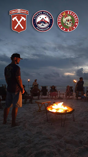 Group of participants wading into the ocean for surf therapy